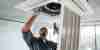 HVAC technician inspecting a vent