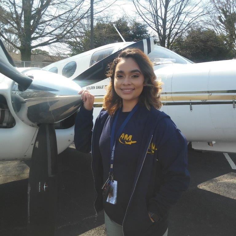Luz Gonzalez standing in front of an airplane