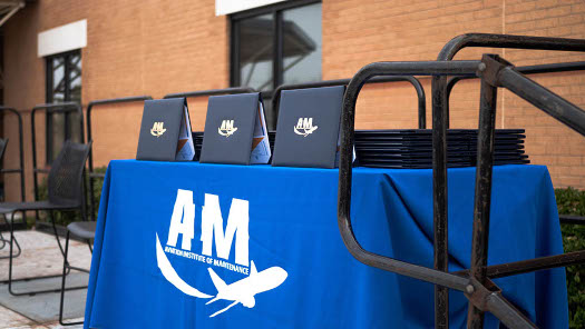 Diplomas for AIM students displayed on a table