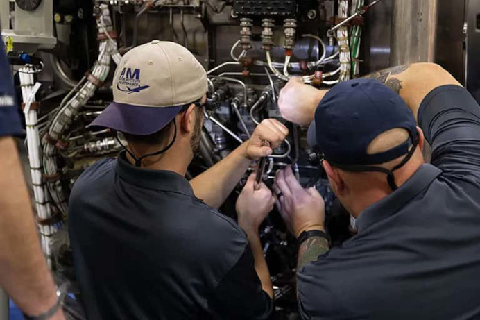 Aviation Maintenance Technician program students working on an engine