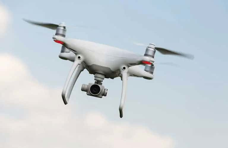 An unmanned drone with a camera in flight