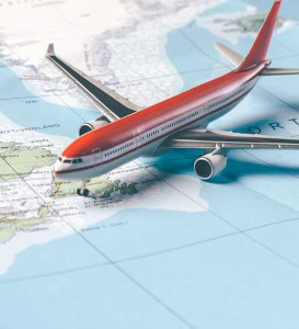 Model airplane sitting on top of a world map