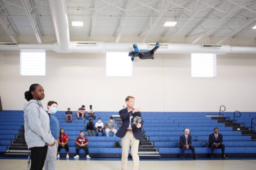 AIM students flying a drone with an instructor watching.