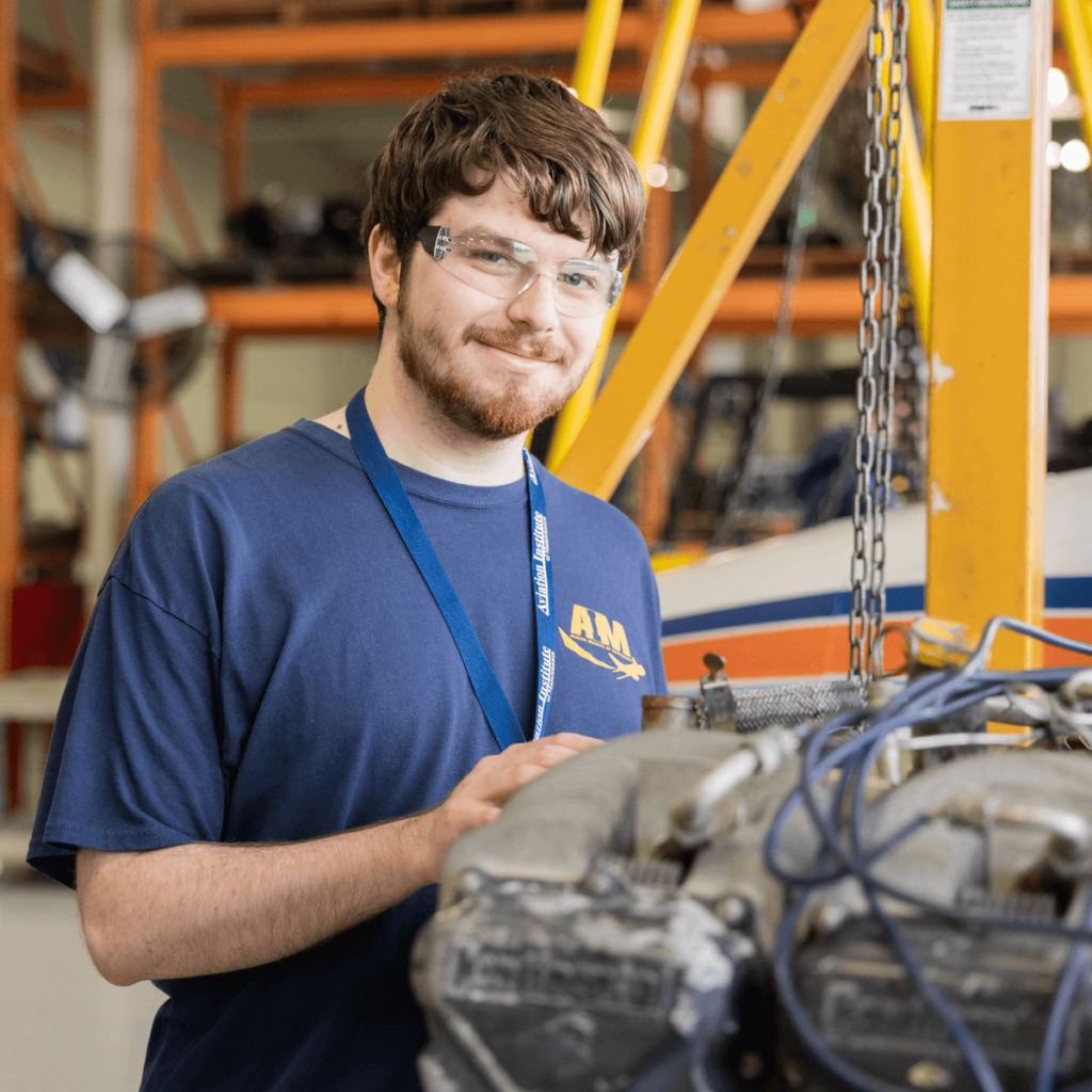 AIM student gaining hands-on experience in engine systems as part of the aviation maintenance technician license program