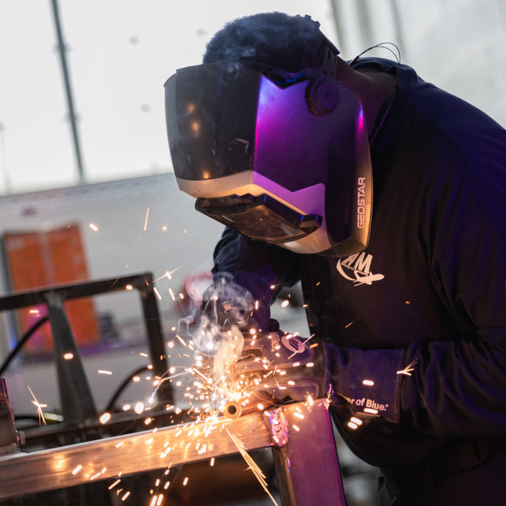A student welds metal during hands-on training at a technical school, showing the skilled trades path beyond community college.